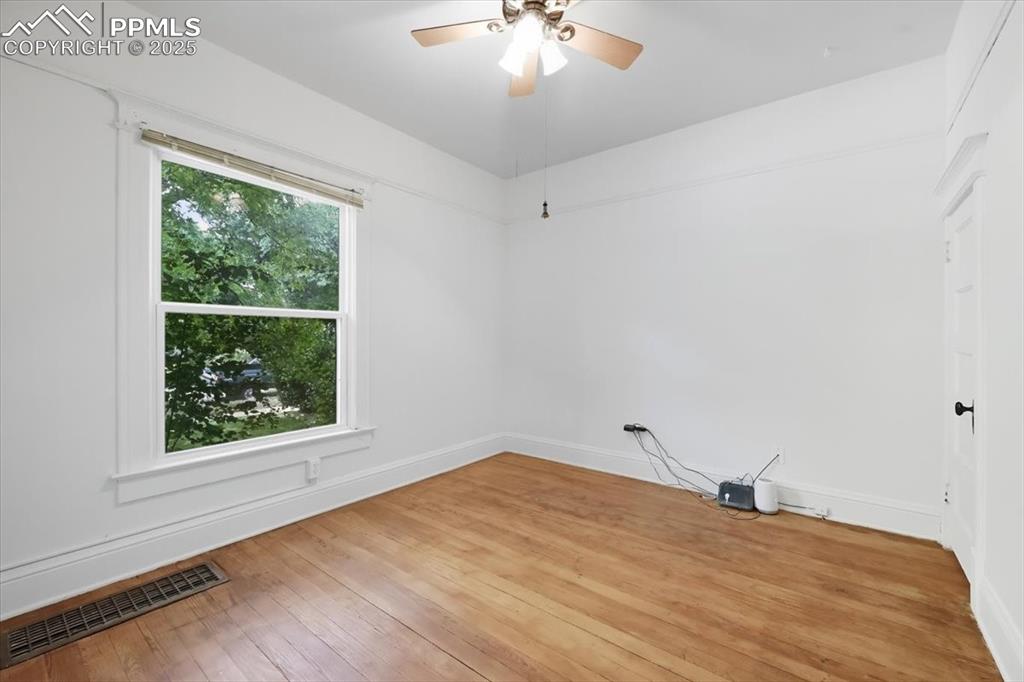 Image 6 of 23: Spare room with hardwood / wood-style flooring and ceiling fan