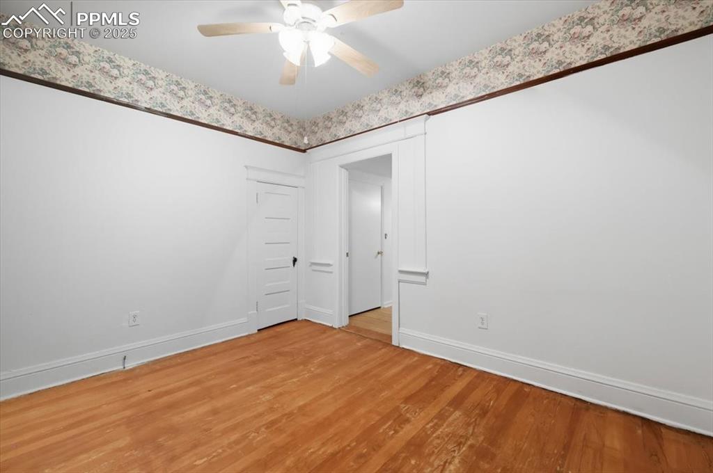 Image 7 of 23: Unfurnished room featuring wood finished floors and a ceiling fan
