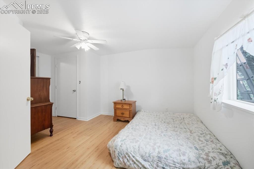 Image 8 of 23: Bedroom featuring light wood finished floors and ceiling fan