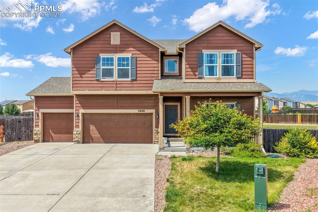 Caption: Craftsman house featuring roof with shingles, driveway, and an attached garage