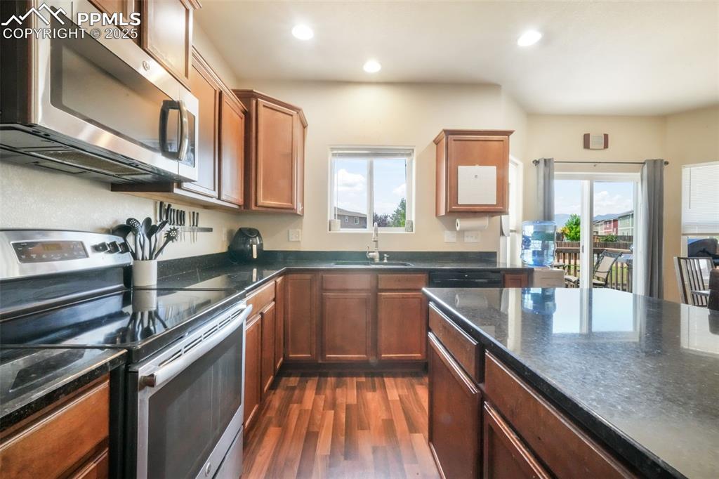 Image 12 of 48: Kitchen featuring appliances with stainless steel finishes, healthy amount
