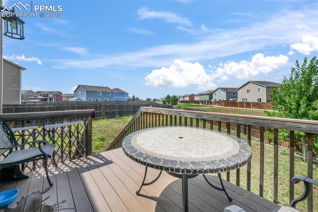 Image 18 of 48: Wooden terrace with a residential view and a fenced backyard