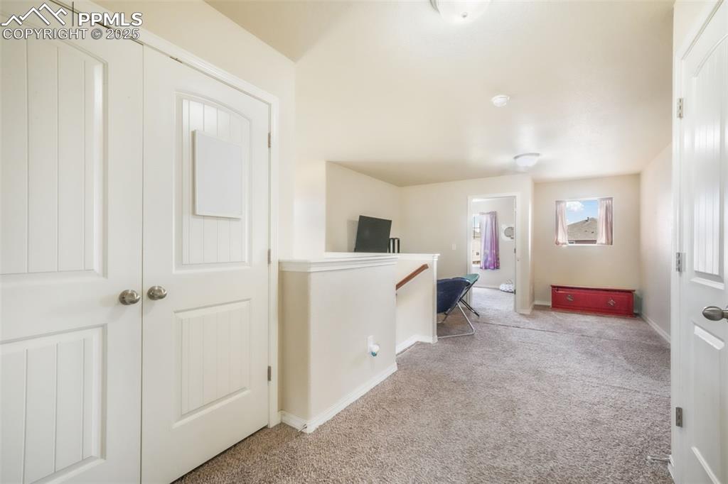 Image 20 of 48: Corridor with carpet flooring and an upstairs landing