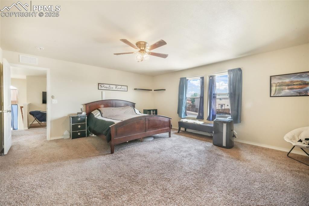 Image 24 of 48: Carpeted bedroom with ceiling fan and baseboards