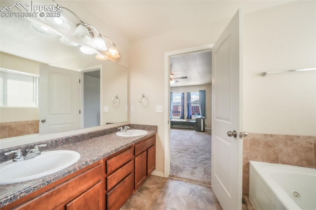 Image 26 of 48: Full bathroom with a bath and a sink