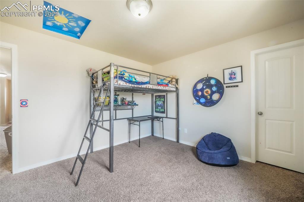 Image 32 of 48: Carpeted bedroom with baseboards