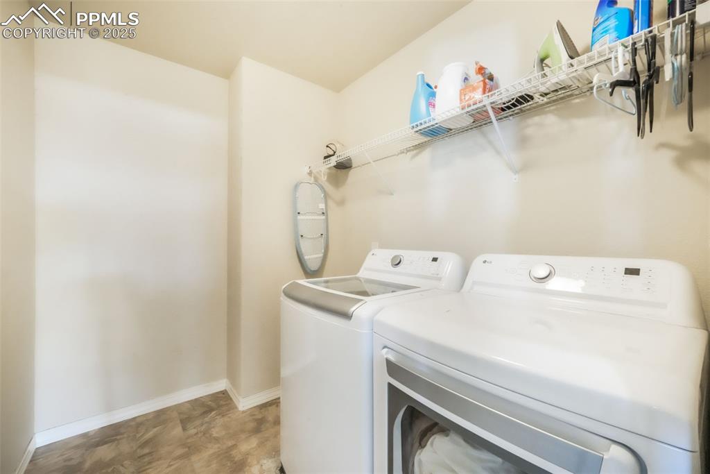 Image 36 of 48: Washroom with washer and clothes dryer and baseboards