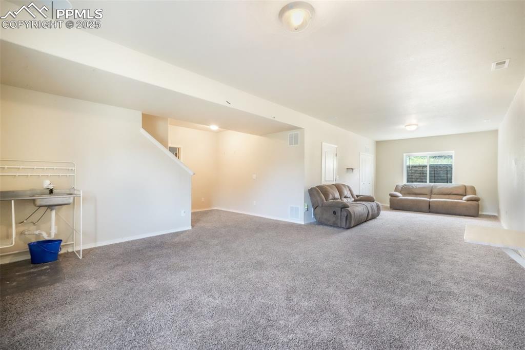 Image 38 of 48: Unfurnished living room with carpet