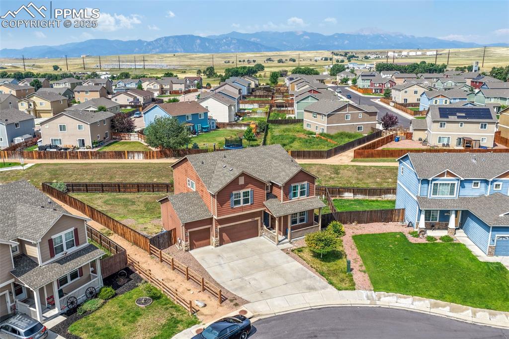Image 4 of 48: Aerial view of residential area featuring mountains