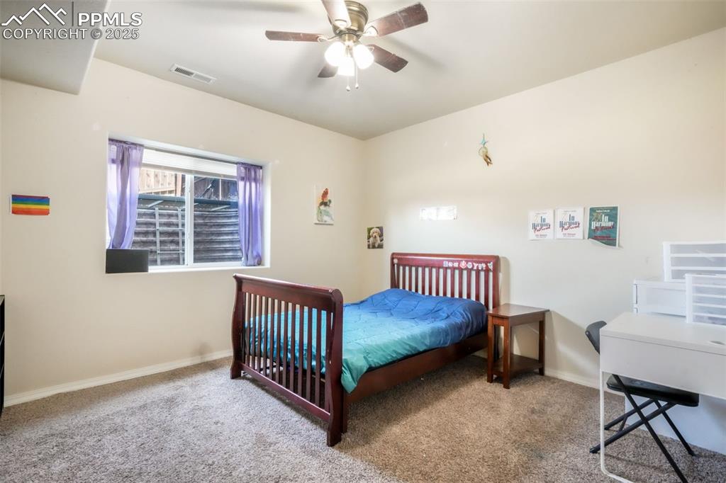 Image 40 of 48: Bedroom with carpet and ceiling fan