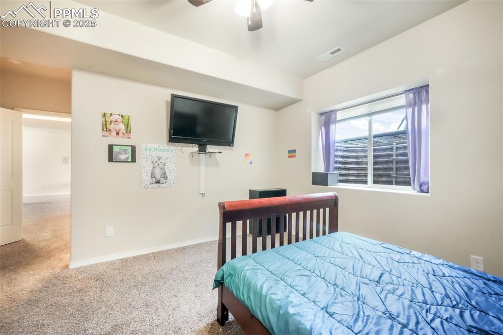 Image 41 of 48: Carpeted bedroom featuring baseboards and a ceiling fan