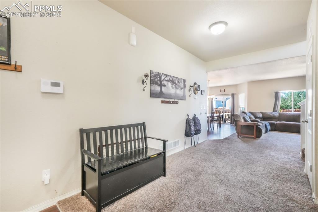 Image 5 of 48: Corridor featuring carpet flooring and baseboards