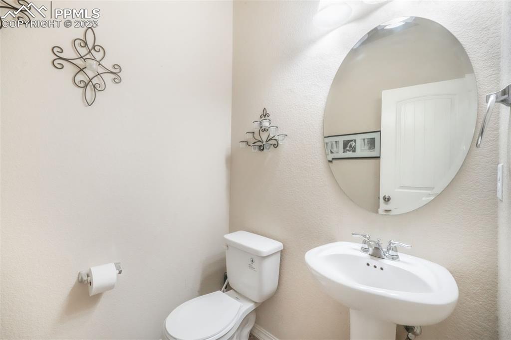 Image 6 of 48: Bathroom with toilet and a textured wall