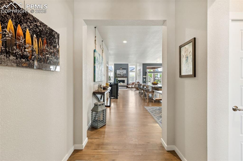 Image 12 of 49: Hallway with wood finished floors and recessed lighting