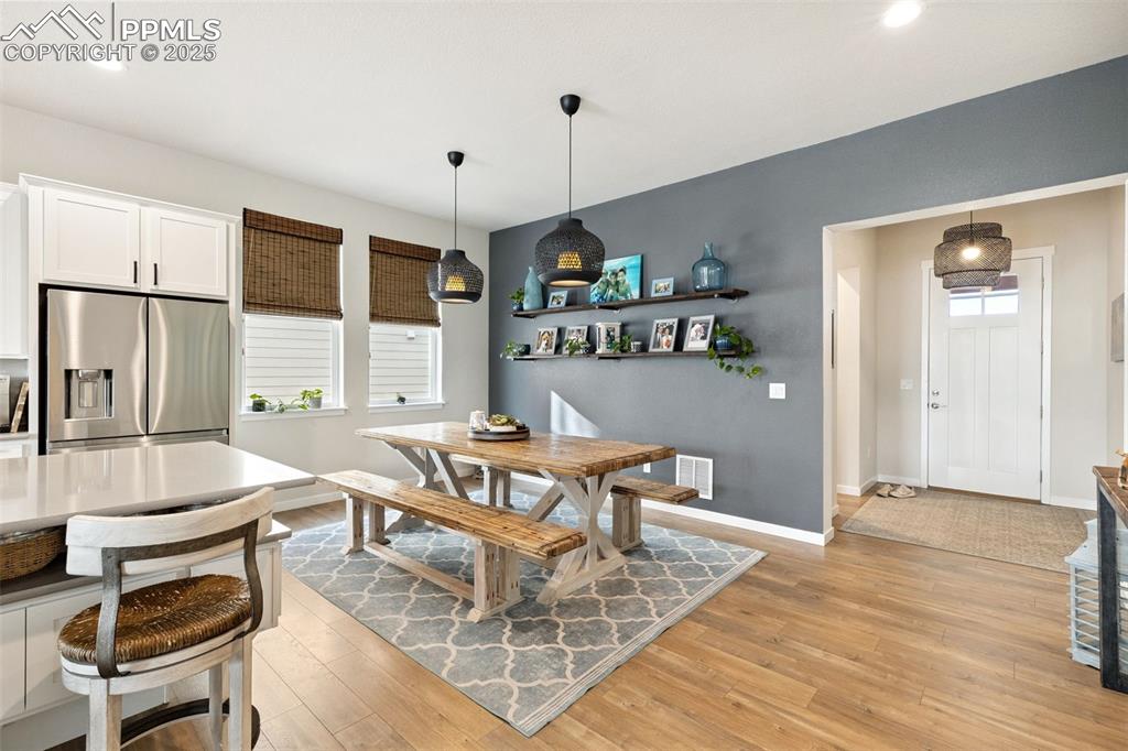 Image 21 of 49: Dining space with light wood-type flooring and recessed lighting