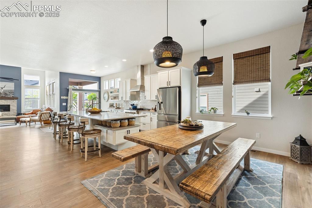 Image 22 of 49: Dining space featuring light wood finished floors, recessed lighting, and a