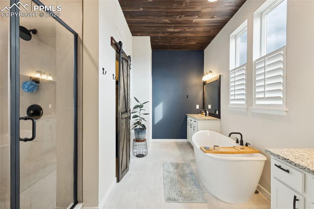 Image 26 of 49: Full bath featuring wooden ceiling, vanity, a stall shower, and a freestand