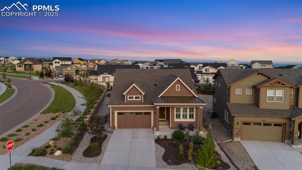 Image 3 of 49: Craftsman inspired home featuring a residential view, concrete driveway, a