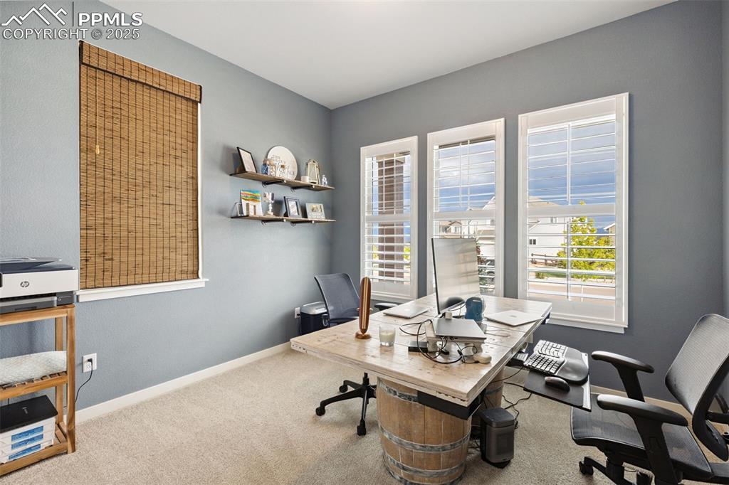 Image 35 of 49: Office space featuring carpet and baseboards