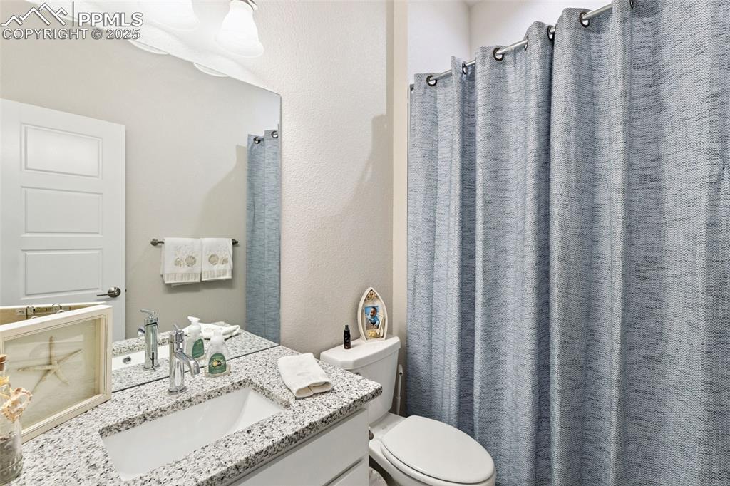 Image 36 of 49: Full bath with vanity and a shower with curtain