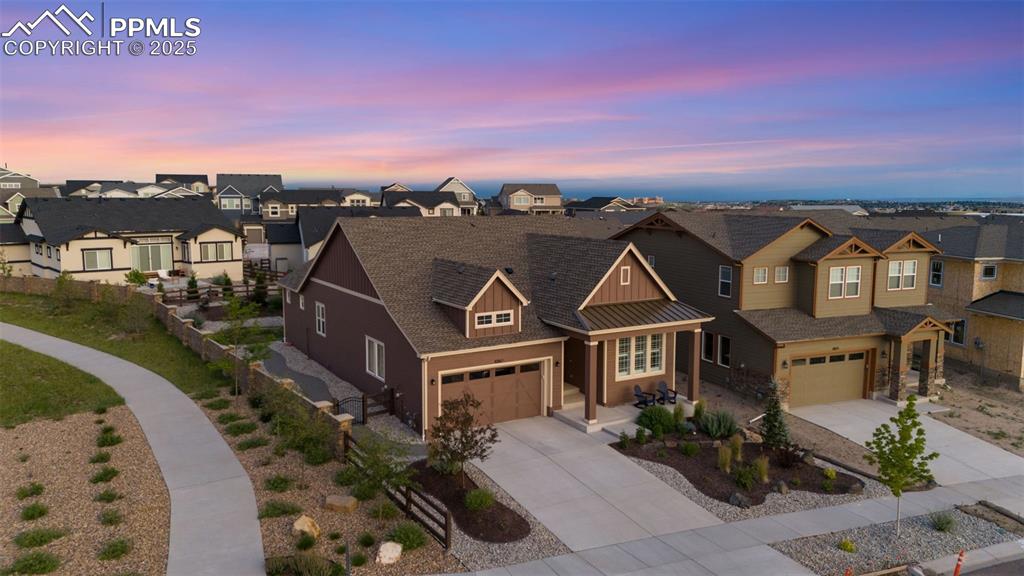 Image 4 of 49: Craftsman-style house featuring a residential view, driveway, roof with shi