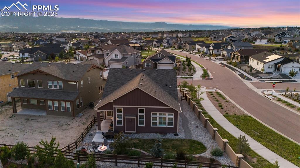 Image 45 of 49: Aerial perspective of suburban area with a mountainous background