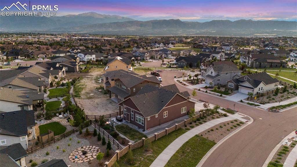 Image 47 of 49: Aerial view at dusk of a mountain view and a residential view