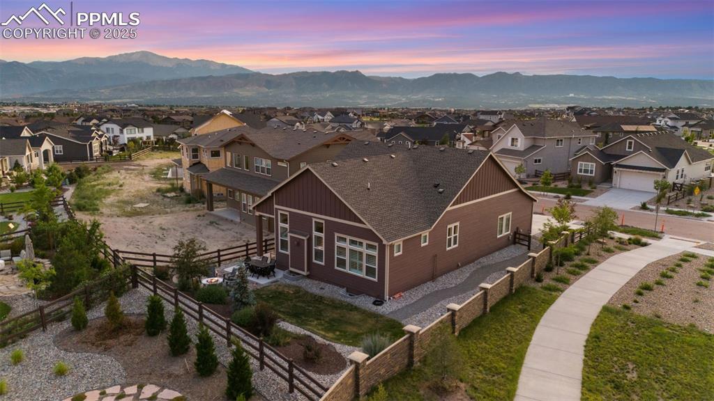 Image 5 of 49: Aerial view of residential area with a mountain backdrop