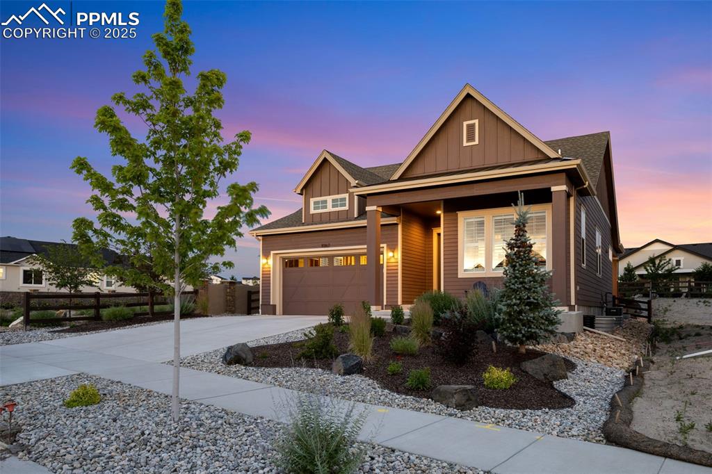 Image 6 of 49: Craftsman-style home featuring board and batten siding, driveway, roof with