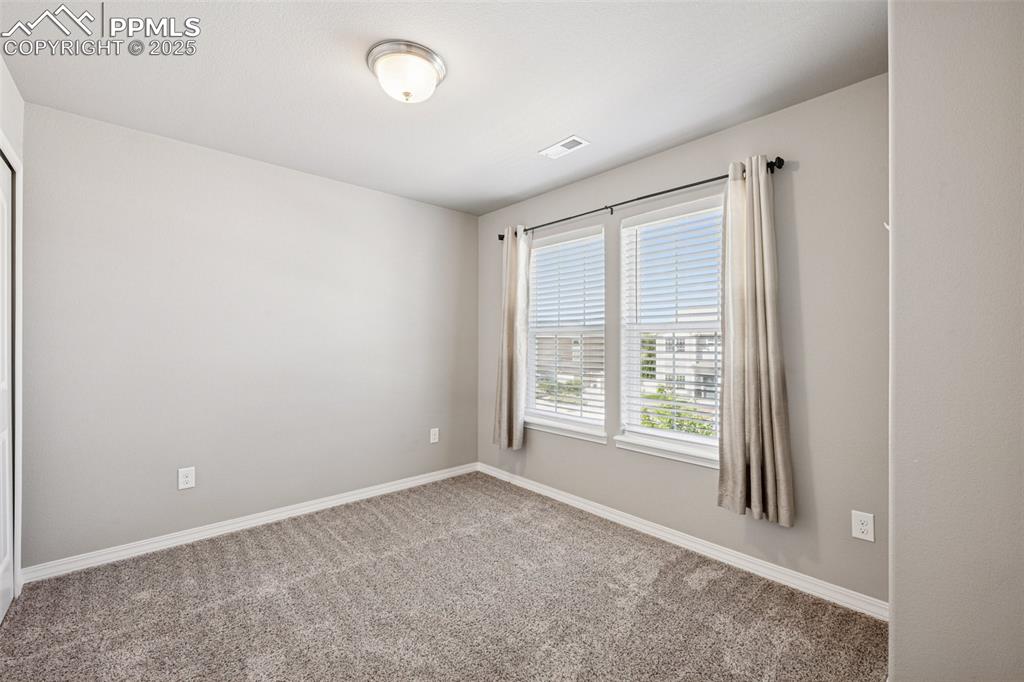 Image 25 of 39: Carpeted empty room with baseboards