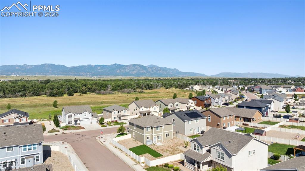 Image 33 of 39: Aerial perspective of suburban area with mountains