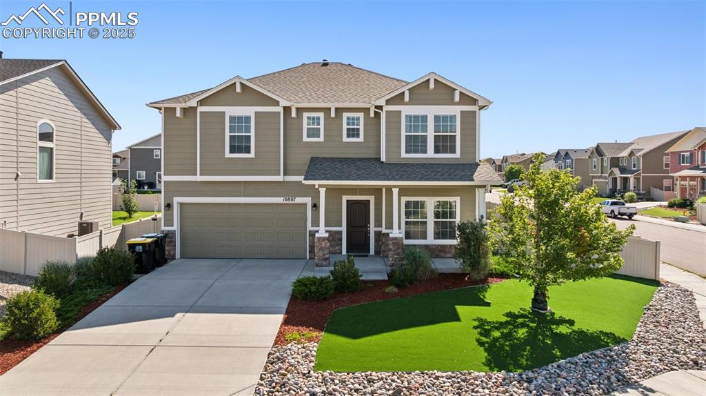 Image 36 of 39: Craftsman-style home featuring roof with shingles, covered porch, an attach