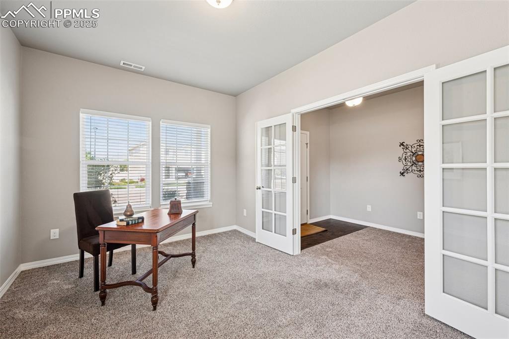 Image 4 of 39: main level Carpeted office with french doors and baseboards