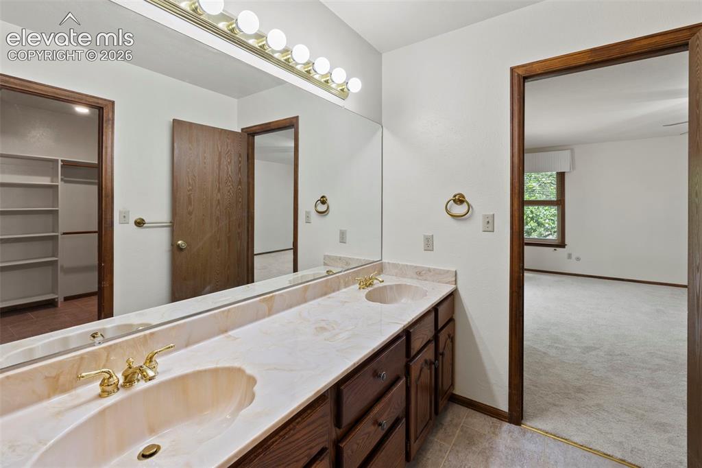 Image 14 of 30: Primary Bathroom with walk-in closet attached