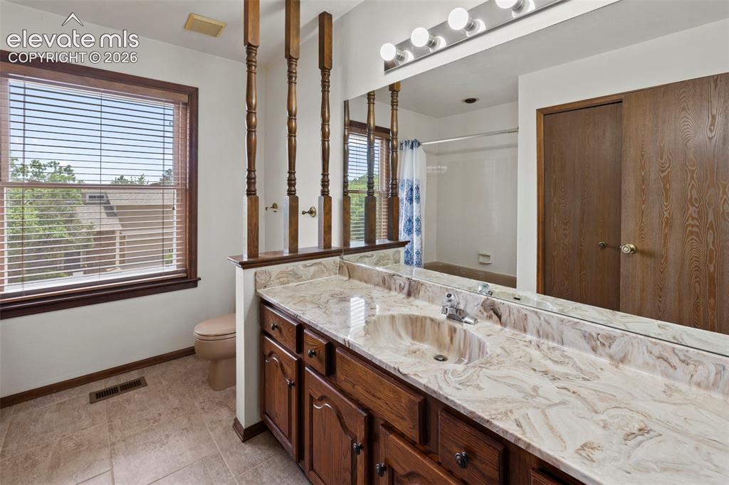 Image 16 of 30: Upper level hall bath with large storage closet