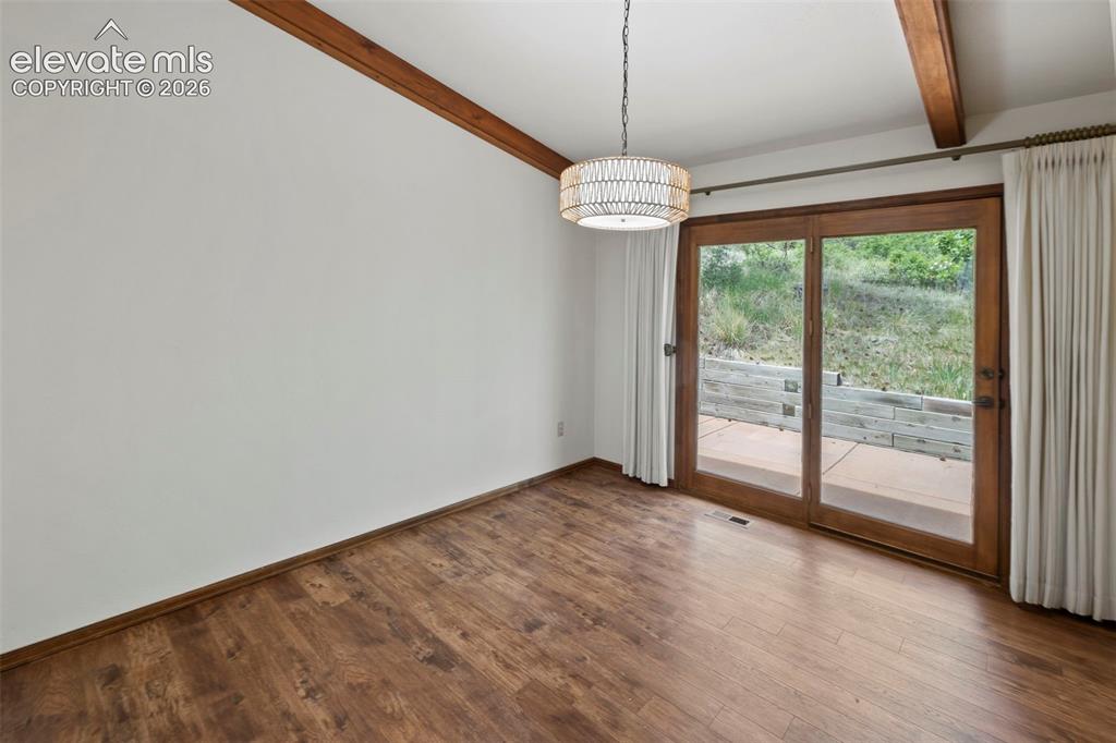 Image 9 of 30: Formal dining room natural light and door that leads to back patio
