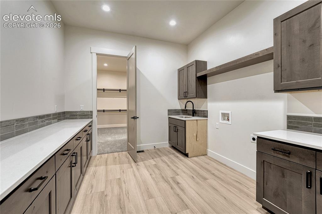 Image 28 of 49: Access this laundry room from the primary bedroom