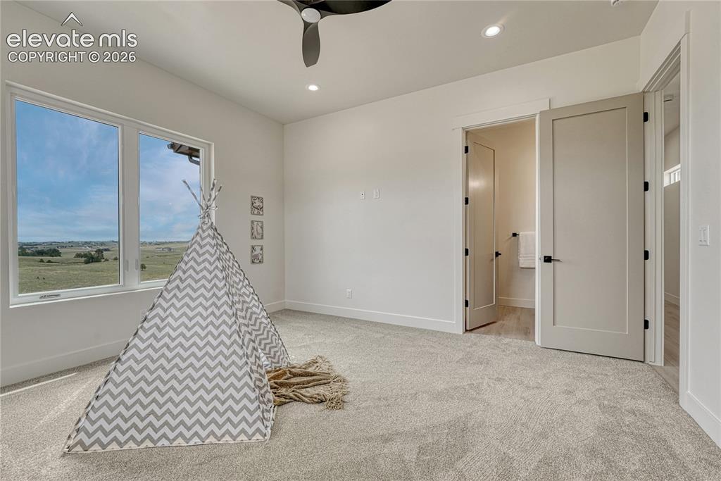 Image 29 of 49: First of two additional main level bedrooms...