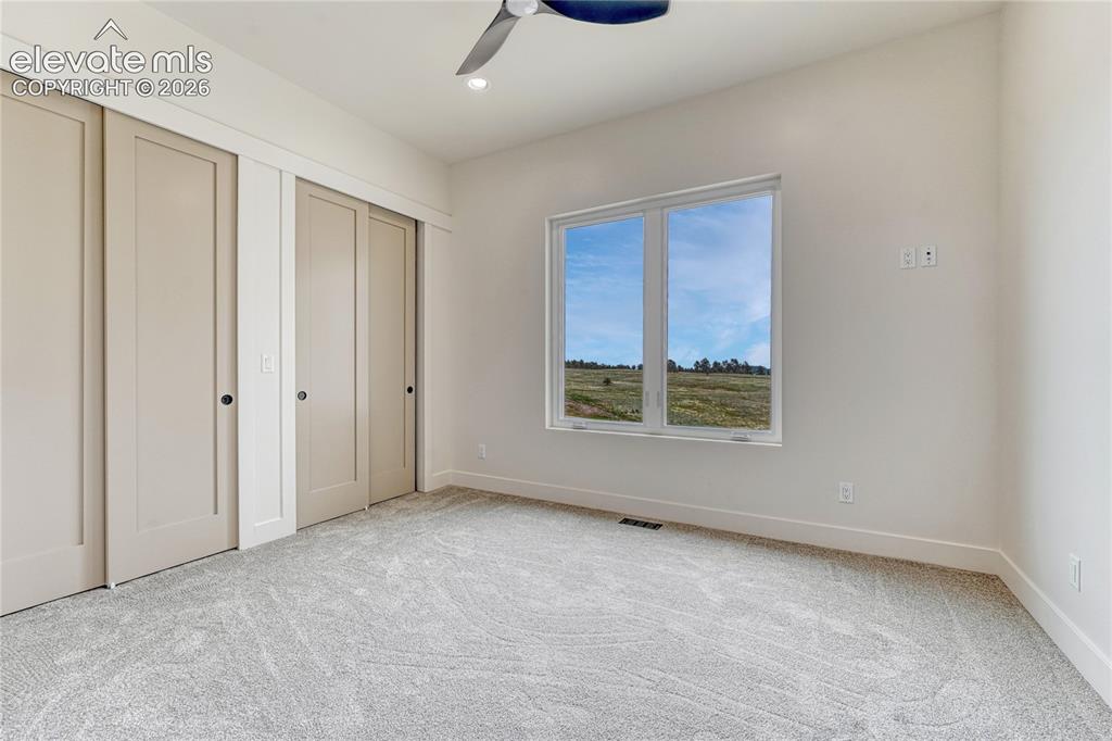 Image 32 of 49: Second of two additional main level bedrooms...