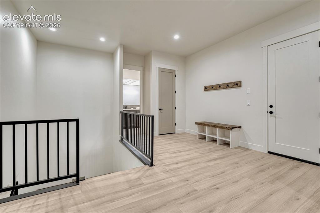 Image 34 of 49: A spacious mud room area accesses the main level, the lower level and the g