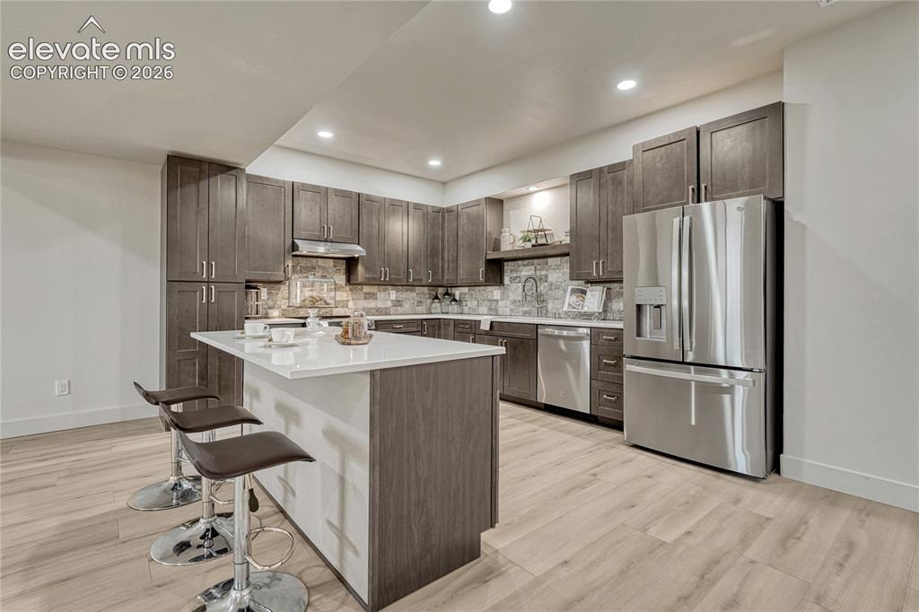 Image 38 of 49: Full kitchen with island...