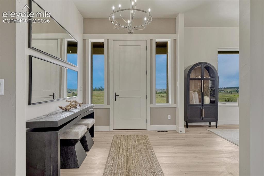 Image 6 of 49: A large foyer and 10 ft ceilings welcome family and friends!