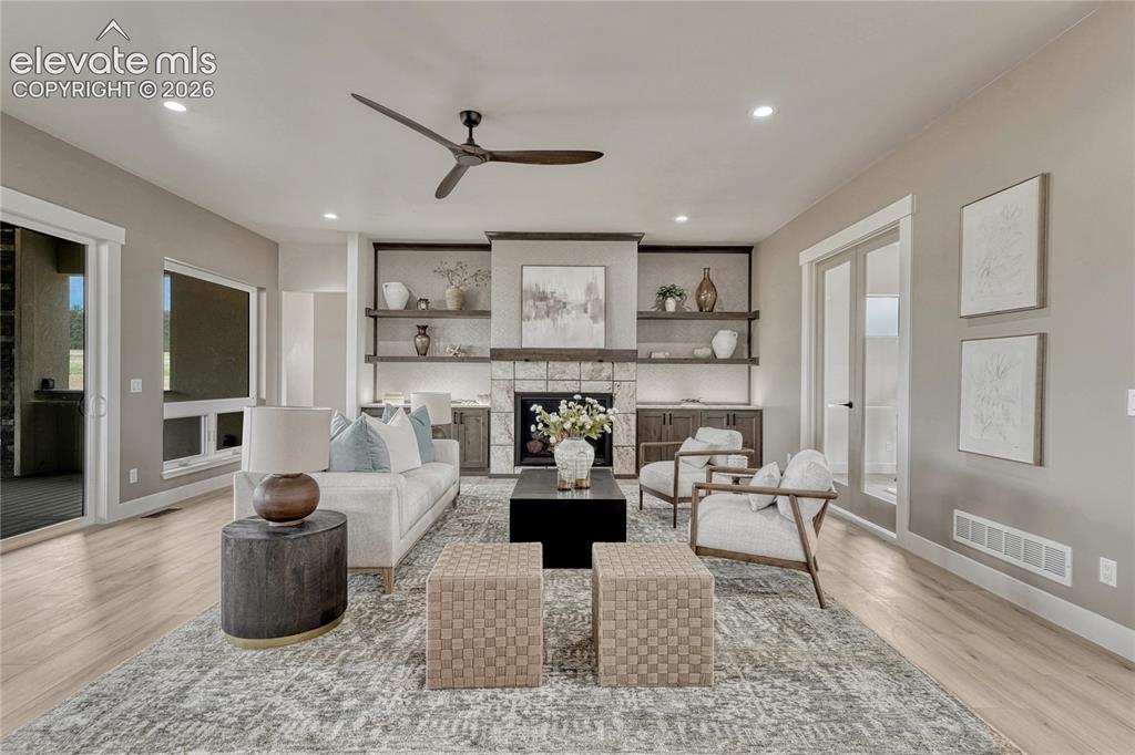 Image 7 of 49: Great room has gas fireplace...