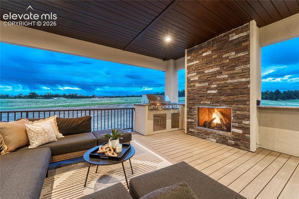 Image 9 of 49: ...to the expansive covered composite deck with gas fireplace.