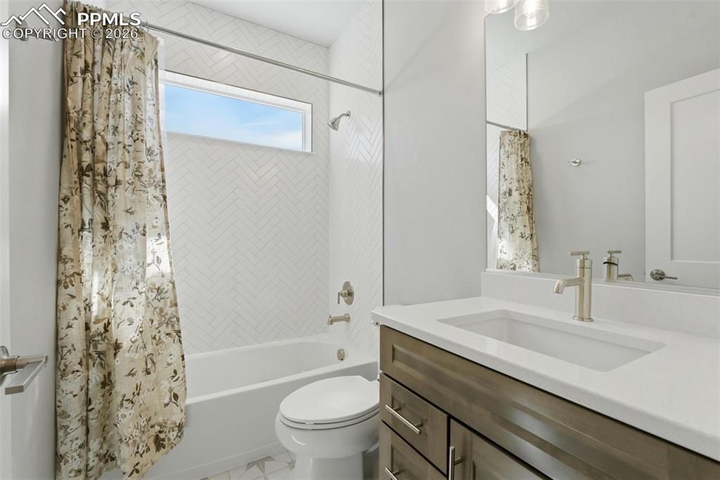 Image 10 of 48: Elegant bathroom with decorative tile work, floating vanity with dual sinks