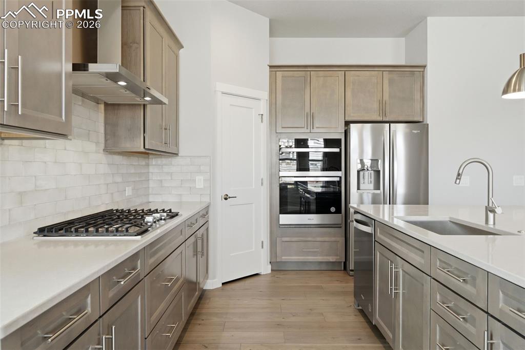 Image 2 of 48: Gourmet kitchen featuring quartz countertops, stainless steel appliances, l