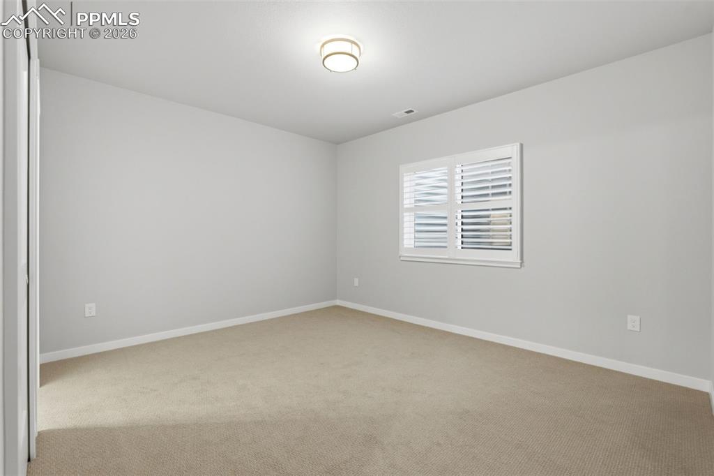 Image 31 of 48: Bright finished basement bonus room with recessed lighting and egress windo