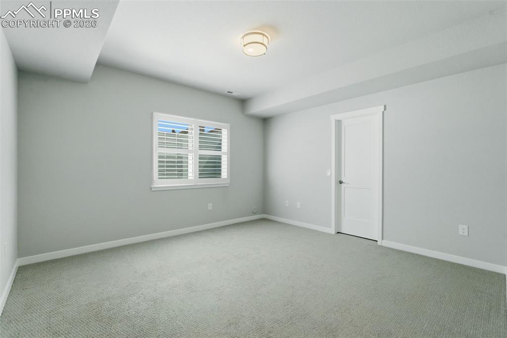 Image 36 of 48: Basement flex room with egress window, carpet, and recessed lighting - grea