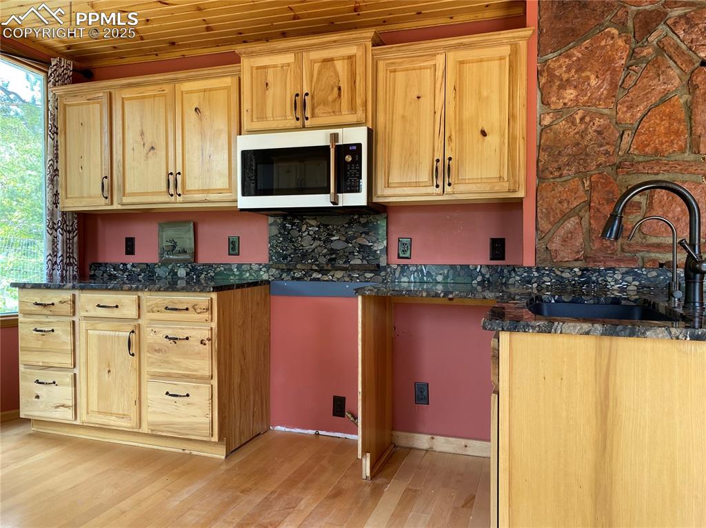 Image 21 of 36: And maple hard wood floors, granite countertops and hickory cabinets