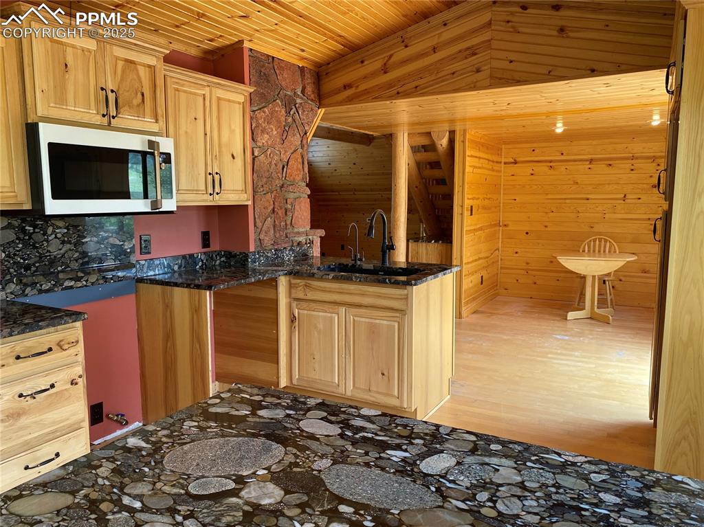 Image 22 of 36: Another look at the granite countertops and hickory cabinets
